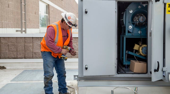 Technician working on rooftop unit