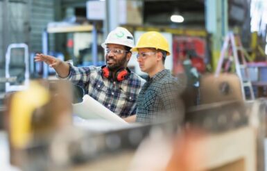 Two people discussing details about pumps and motors